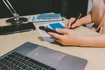 Tax deduction planning concept. Women use a calculator to calculate expenses and taxes to receive...