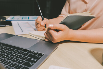 Tax deduction planning concept. Women use a calculator to calculate expenses and taxes to receive...