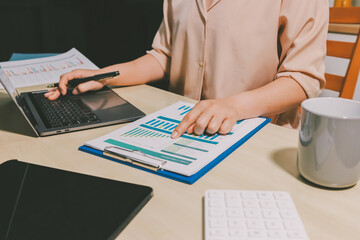 Tax deduction planning concept. Women use a calculator to calculate expenses and taxes to receive...