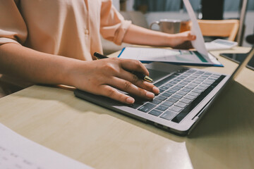 Tax deduction planning concept. Women use a calculator to calculate expenses and taxes to receive...