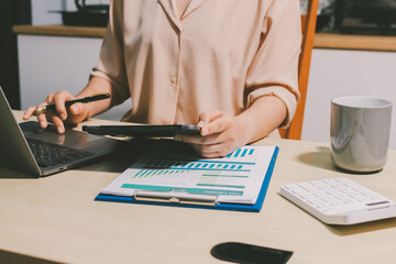 Tax deduction planning concept. Women use a calculator to calculate expenses and taxes to receive...