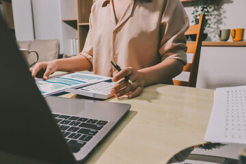 Tax deduction planning concept. Women use a calculator to calculate expenses and taxes to receive...