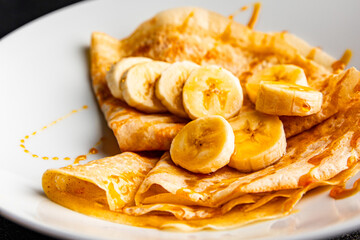 Crepes banana syrup pancakes breakfast dish dessert organic product fresh tasty gourmet food background on the table rustic food top view copy space