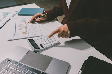 Tax deduction planning concept. Women use a calculator to calculate expenses and taxes to receive...