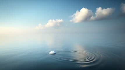Obraz premium Serene Ocean Scene with Ripples and Iceberg on Calm Waters at Dusk