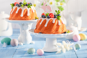 Delicious Easter ring cake with flower and painted eggs.