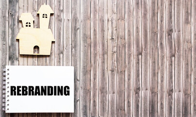 The rebranding word is written on a notebook and a wooden background