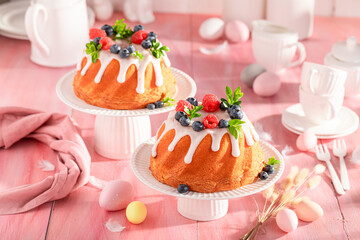 Tasty ring cake for Easter on holiday table with decorations.