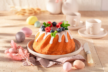 Homemade ring cake for Easter with lemon icing and fruit.