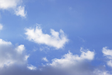 white fluff in the sky, white haze accumulation with blue background, many puffy clouds with blue...