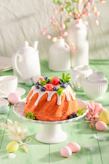 Delicious Easter ring cake with lemon icing and fruit.