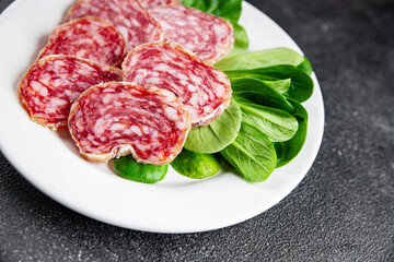Dry-cured sausage salami appetizer dish fresh delicious gourmet food background on the table rustic...