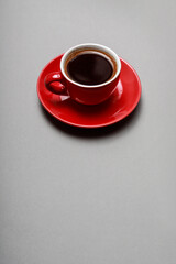 Red cup with dark coffee.