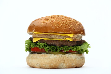 A classic hamburger with a sesame seed bun, beef patty, cheese, lettuce, tomatoes, and pickles , isolated in white