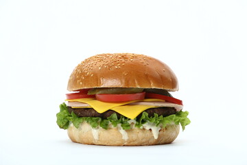A classic hamburger with a sesame seed bun, beef patty, cheese, lettuce, tomatoes, and pickles , isolated in white