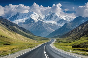 Scenic highway leading through majestic mountains under a bright blue sky