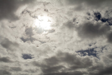 A vast plain beneath a clouded sky, where clouds stretch across the sky, creating a moody and...