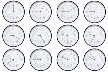  A set of twelve round wall clocks with dark brown frames and white faces showing 5-minute time...