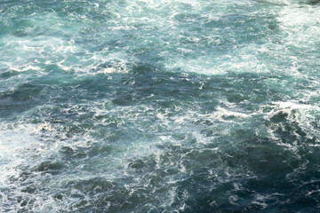 The clear, flowing water creates gentle ripples and reflections, with light playing off the surface