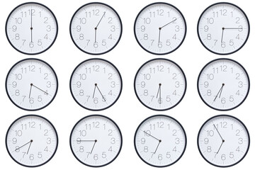  A set of twelve round wall clocks with dark brown frames and white faces showing 5-minute time...