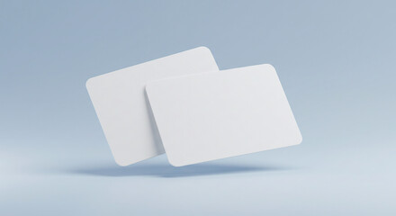 Two blank white cards floating on a light blue background, ideal for business card or credit card mockups