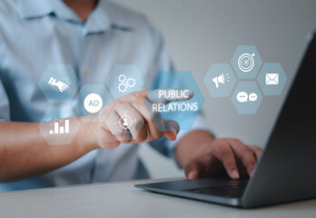 Businessman using laptop with public relations on virtual screen for marketing strategy, public relations concept, communication, advertising, marketing.