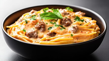Creamy, cheesy spaghetti with ground beef, garnished with fresh herbs.  A delicious comfort food dish