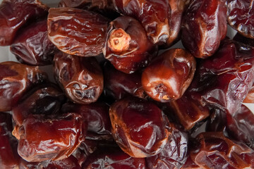 a pile of dates in a plastic box isolated white background