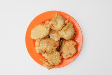flour fried tofu on an orange plate isolated in white background