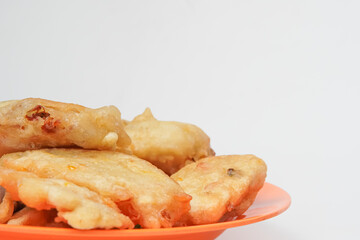 flour fried tofu on an orange plate isolated in white background
