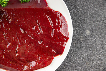 Raw liver beef veal meat steak liver grill appetizer dish fresh gourmet food background on the...