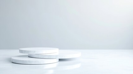 Simple white circular podiums on a white surface