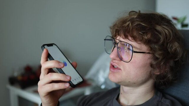 ChatGPT conversation home user speaking into phone casual tone AI assistant smart tech interaction relaxed expression remote dialogue digital habit modern lifestyle