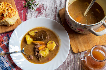 Veal stew,veal soup with potatoes on a wooden table.