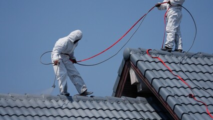 Professional painter on roof Working at heights is dangerous.