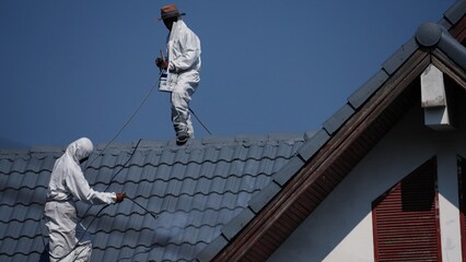 Professional painter on roof   Working at heights is dangerous.