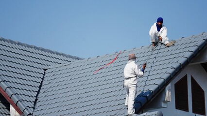 Professional painter on roof   Working at heights is dangerous.