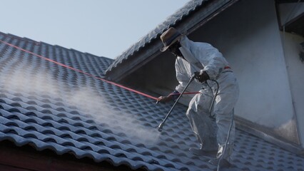 Professional painter on roof Working at heights is dangerous.
