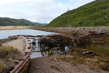 On the cemetery of old ships on a cloudy July morning. Teriberka. Murmansk Oblast, Russia