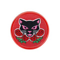 Fototapeta premium A round embroidered patch features fierce black panther head with pink eyes and pink nose, surrounded by vibrant red roses on red background. design is bold and striking