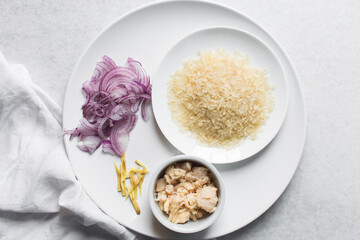 Top view of ingredients for making rice and chicken porridge
