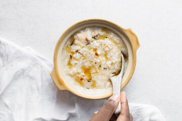 Top view of rice and chicken porridge in a claypot