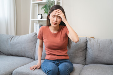 Young Asian females feeling dizzy after standing too fast, have symptoms of low blood pressure