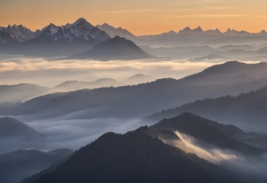 Majestic mountain range at sunrise with morning mist and distant peaks