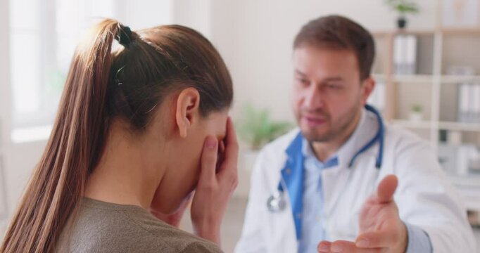 Male doctor support, encouragement for female patient problem, illness, sharing bad lab results, negative news, visiting clinic room for medical care, discussing treatment plan, explaining serious