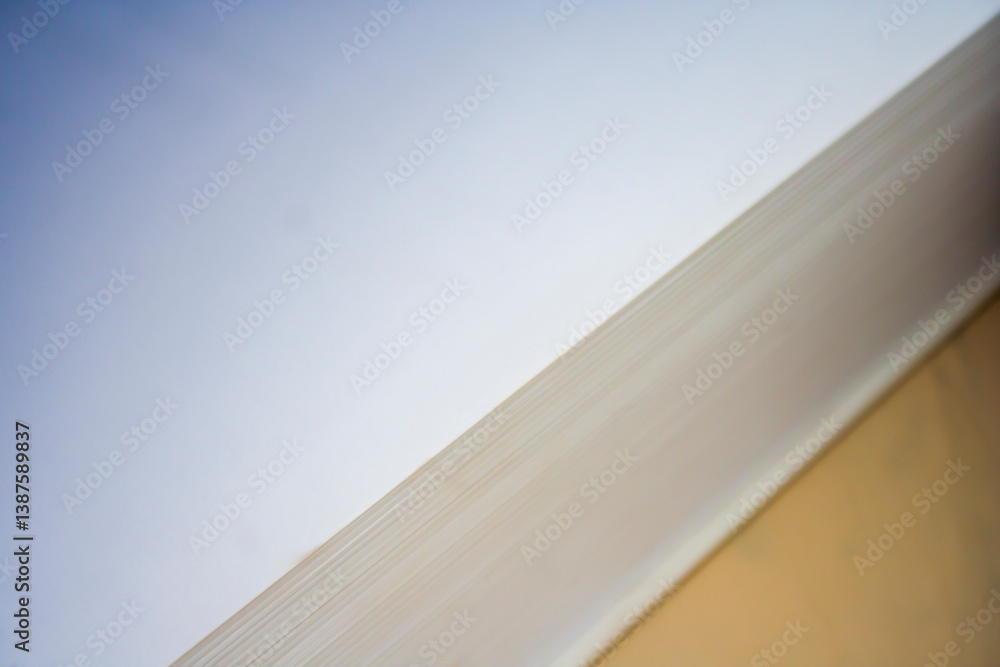 Poster abstract close-up of layered paper surfaces with soft lighting, showcasing texture and subtle color 