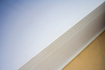 Obraz premium Abstract close-up of layered paper surfaces with soft lighting, showcasing texture and subtle color transitions for minimalistic backgrounds or design projects.