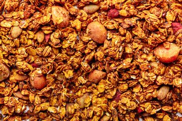 Granola texture. Organic gourmet muesli, overhead flat lay shot. Oat flakes, honey, nuts, and berries in a healthy mix