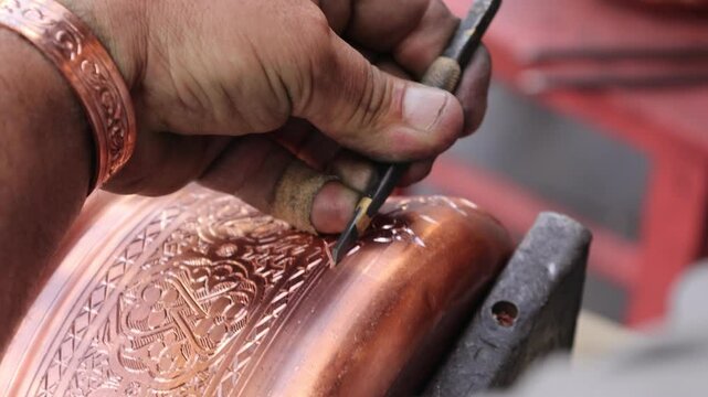 Traditional coppersmithing in Gaziantep. Craftsman engraving on a copper metal plate