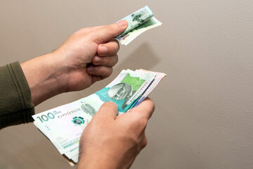 A person handing over a banknote to make a payment or financial transaction. Bribery, corruption.